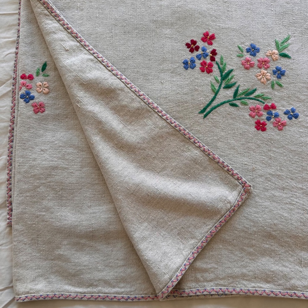 Vintage linen tablecloth with vibrant floral embroidery on a natural base 55x92"